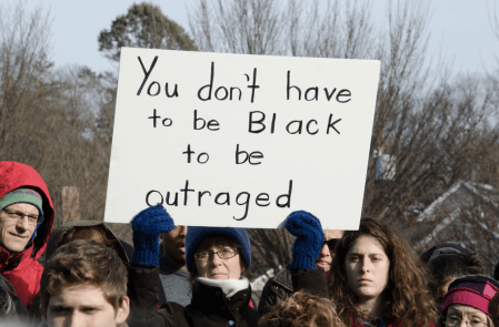 man holding sign that says 