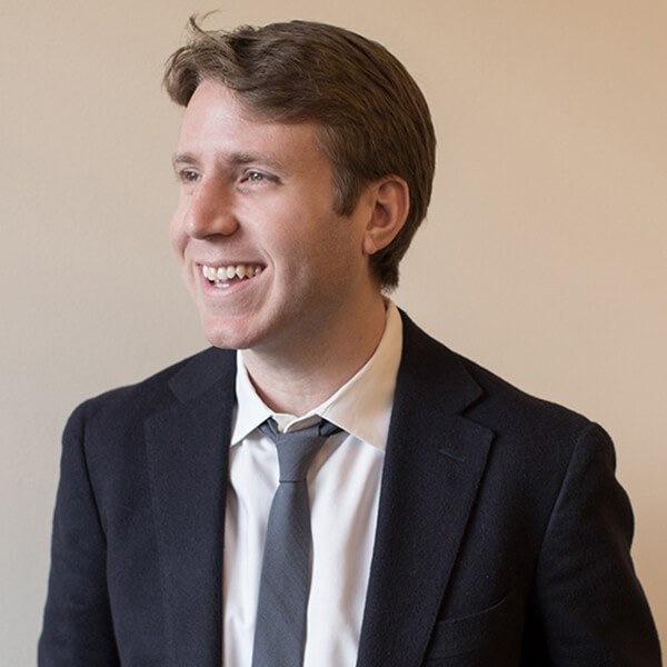 Man smiling, looking away from the camera