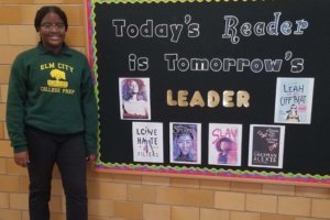 Kaiden standing by a bulletin board