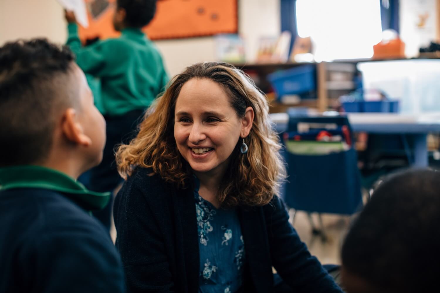 A teacher smiles at her students.