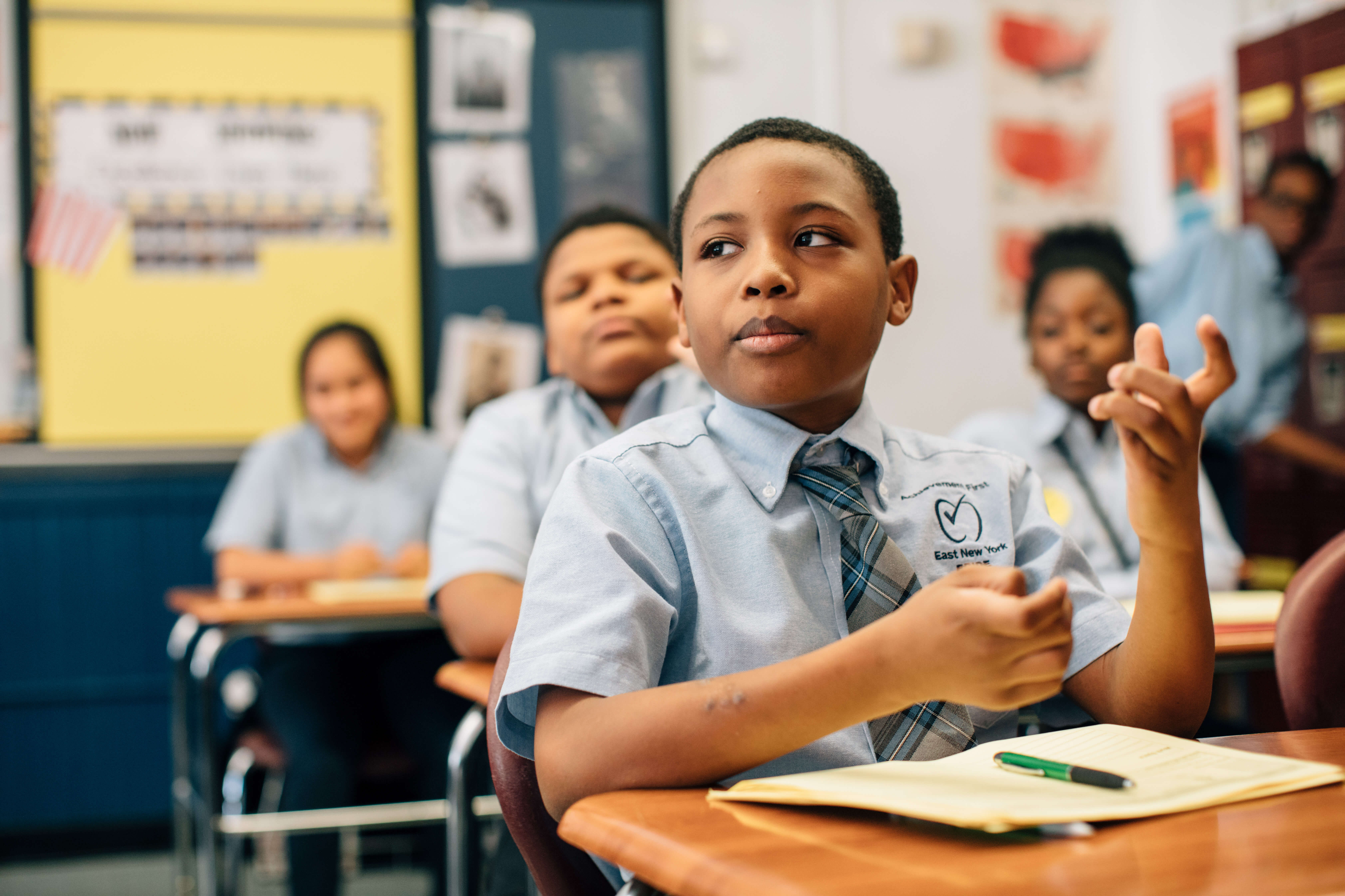 middle school boy participating in class