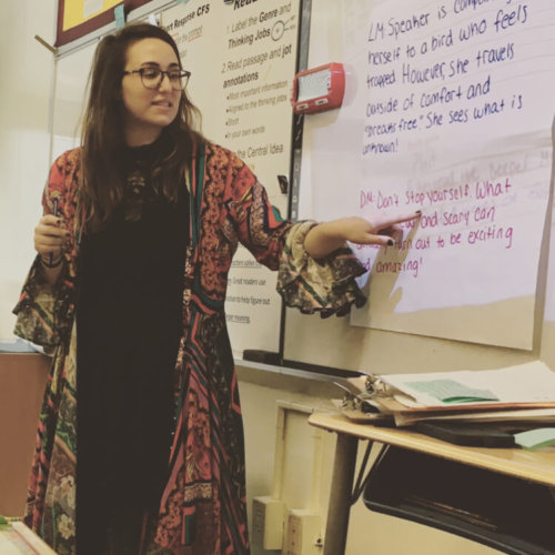 A teacher demonstrates a lesson on the board