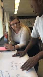 Ethel McGinn and a student reviewing work.