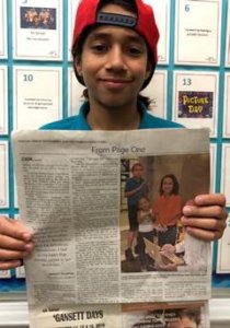 Student Jeremi holding newspaper