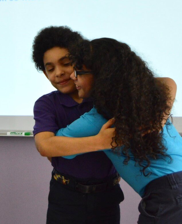 Two scholars hugging