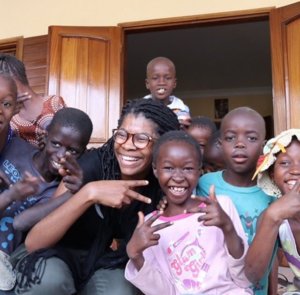 Ryana posing with children from Senegal