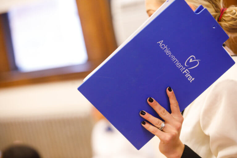 teacher holding up folder