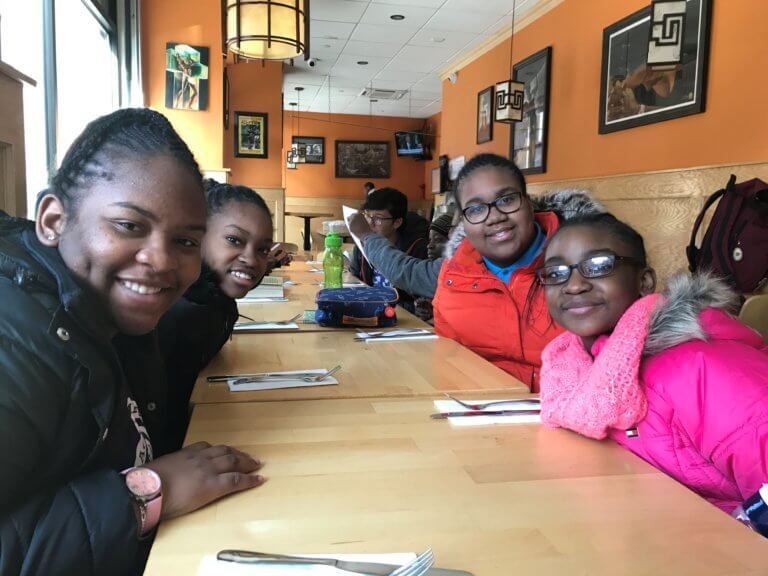 Students smiling at a restaurant