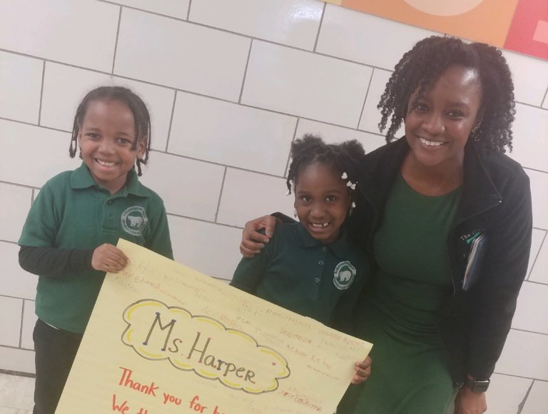 Alicia Harper smiling with two students from AF Brownsville Elementary