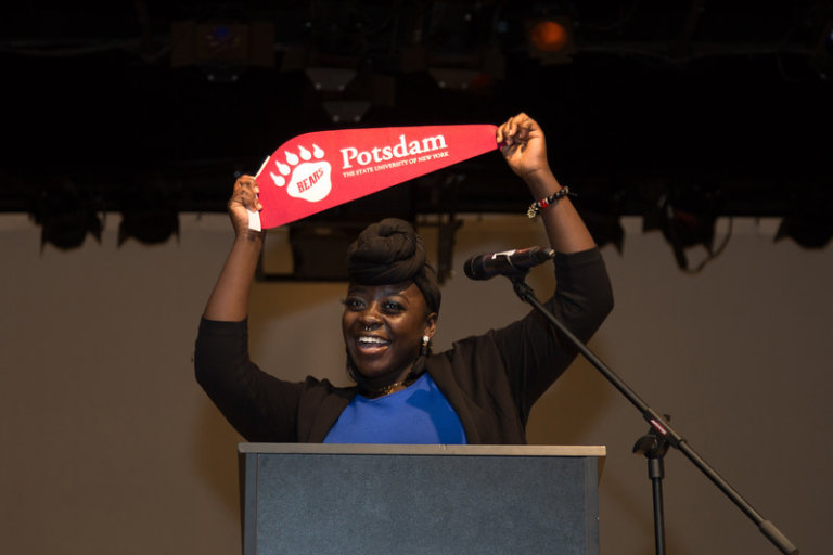 Jessica holding up a Potsdam pennant