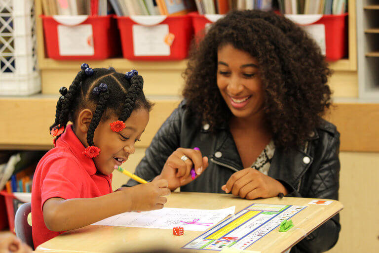 Shamel sitting down with a student