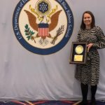 Courtney with the Blue Ribbon Schools plaque