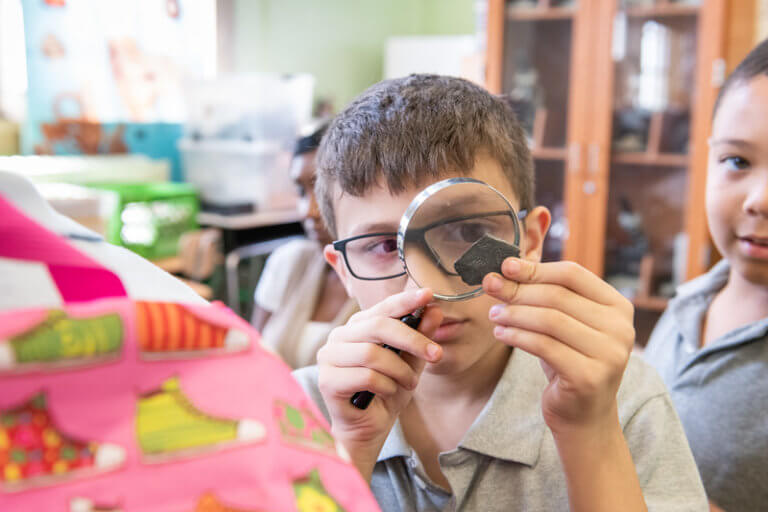 scholar using a magnifying glass