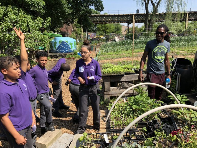 Students work in a garden outdoors
