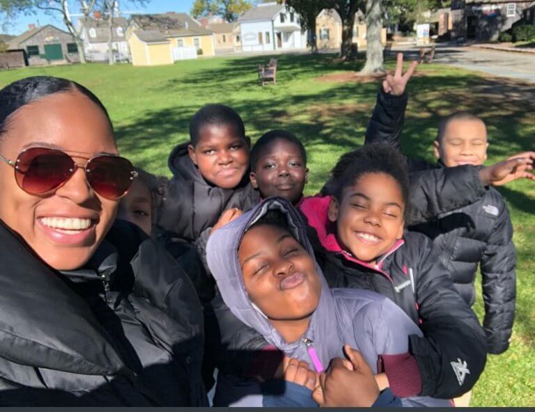 Leslie poses with students